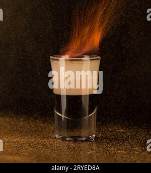 Bicchierino con alcol su sfondo scuro Foto Stock