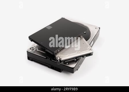 Mucchio di una varietà di computer disco rigido HDD e SSD isolati su sfondo bianco. Memorizzazione dei dati hardware del computer Foto Stock