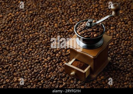 coffee grinder on the roasted beans background Foto Stock