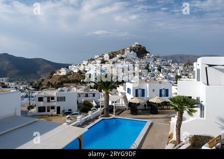 IOS, Grecia - 8 settembre 2023: Veduta di un pittoresco hotel con piscina e del villaggio di iOS Grecia in bianco sullo sfondo Foto Stock