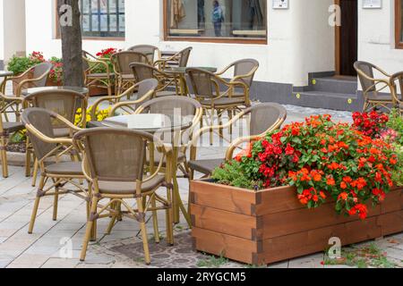 Ristorante con sedie e tavoli vuoti. Terrazza all'aperto con mobili di bambù senza persone. Foto Stock