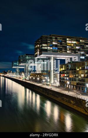 Vista aerea delle gru illuminate sul canale di notte allo Zollhafen di Colonia, Germania Foto Stock