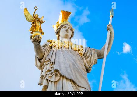 Statua di Pallas Athena di fronte al Parlamento austriaco, Vienna, Austria, sullo sfondo blu del cielo nuvoloso Foto Stock