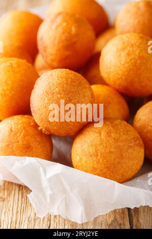 Krata Kanom kai nok o palle di patate dolci fritte, sono un comune primo piano del cibo di strada tailandese sul tavolo di legno. Verticale Foto Stock