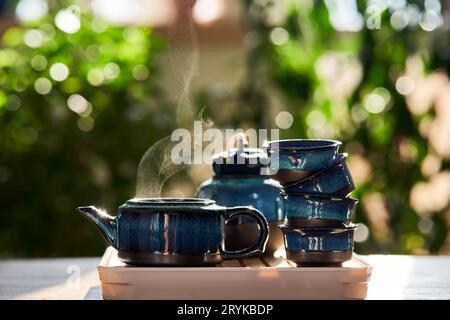 Set da tè di colore blu intenso su uno sfondo verde. Foto Stock