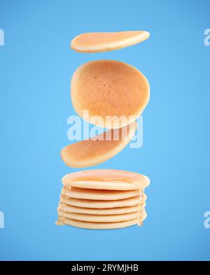 Molti gustosi pancake freschi che cadono su sfondo azzurro Foto Stock