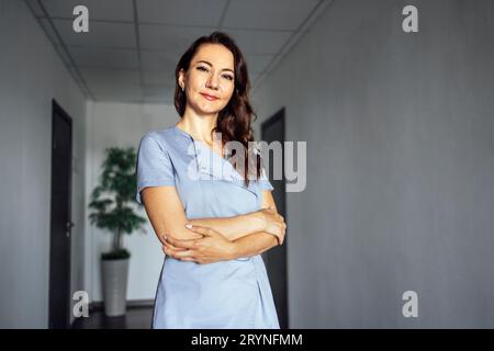 Medico donna sorridente su sfondo grigio chiaro Foto Stock