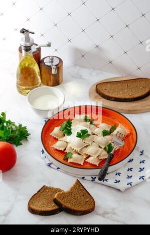 Piastra con gustosi ravioli sulla tabella, vista dall'alto Foto Stock