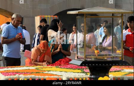 Nuova Delhi, India. 2 ottobre 2023. La gente poggia petali di fiori mentre si rende omaggio al Mahatma Gandhi in occasione del suo 154° anniversario di nascita al suo memoriale Rajghat. Gandhi Jayanti viene celebrato ogni anno il 2 ottobre. Mahatma Gandhi, noto anche come il padre della Nazione, Bapu o Mahatma, svolge un ruolo chiave nel movimento per la libertà dell'India e dimostra il potere della non violenza. Ha ispirato leader in tutto il mondo con i suoi valori e principi. (Foto di Naveen Sharma/SOPA Images/Sipa USA) credito: SIPA USA/Alamy Live News Foto Stock