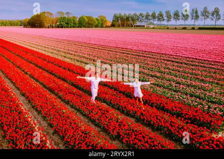 Coppia di uomini e donne in campo tulipano fiore nei Paesi Bassi durante la primavera Foto Stock