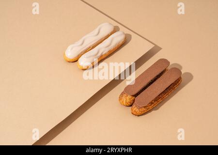 Un set di deliziose ciambelle smaltate in una varietà di sapori, disposte su carta di cartone in un'invitante esposizione Foto Stock