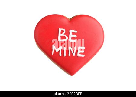 Delizioso biscotto a forma di cuore con la frase Be Mine isolata su bianco. San Valentino Foto Stock