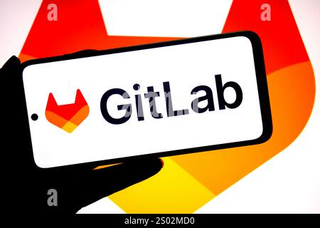 India. 17 dicembre 2024. In questa illustrazione fotografica, un logo Gitlab viene visualizzato su uno smartphone e sullo sfondo. Credito: SOPA Images Limited/Alamy Live News Foto Stock