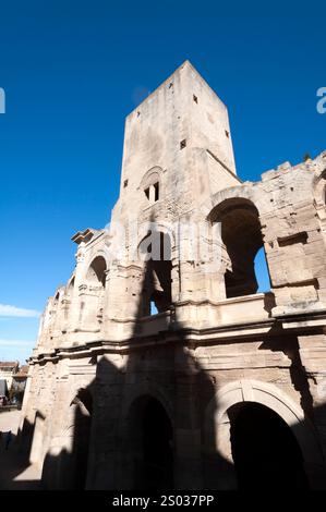 Anfiteatro romano al tramonto con l'ombra della chiesa riflessa sulla facciata, Arles, Bouches du Rhône, Francia Foto Stock