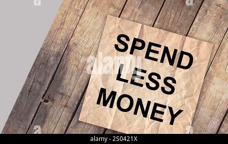 Spendi meno parole scritte su pezzi di carta bianca con sfondo. Concetto di finanza aziendale. Immagine concettuale. Foto Stock