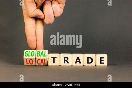 Simbolo commerciale globale o locale. Parole concettuali commercio globale commercio locale su bellissimi blocchi di legno. Splendido sfondo grigio. Mano d'affari. Affari Foto Stock