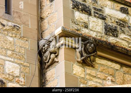 Le due statue sul muro sono di gnomi, uno dei quali regge una spada. Gli gnomi sono scolpiti nel muro di pietra, e sembrano sembrare un Foto Stock