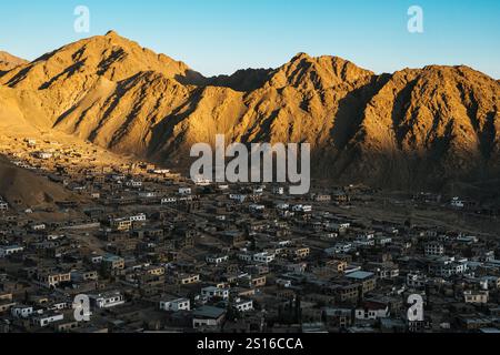 Vista panoramica dall'alto angolo della città di Leh e delle aspre montagne dell'Himalaya durante l'ora d'oro, Ladakh, India. Foto Stock