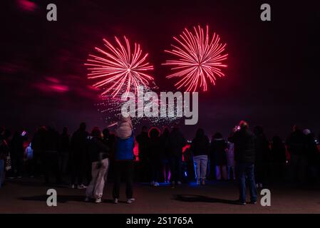 Fuochi d'artificio di Capodanno sul lungomare di Southend on Sea, Essex, Regno Unito. Folla di persone che guardano lo spettacolo pirotecnico a mezzanotte, quando 2024 diventa 2025 Foto Stock