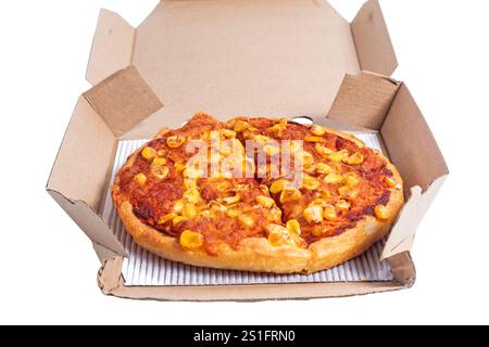 Una pizza di verdure appena sfornata condita con formaggio e mais, splendidamente presentata in una scatola di cartone da asporto. Ideale per la consegna di alimenti e per asporto Foto Stock