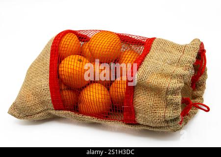 Deliziosi mandarini in un sacchetto di iuta su sfondo bianco Foto Stock