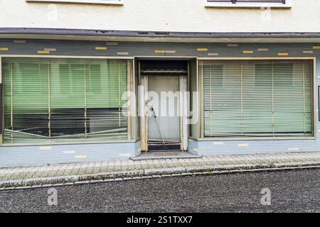 Negozio in rovina con persiane chiuse Foto Stock