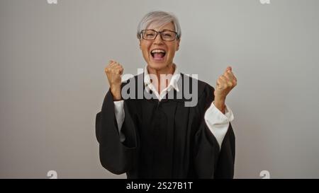 Donna che festeggia indossando l'abito nero su sfondo bianco, mostrando entusiasmo e successo Foto Stock