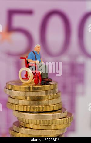 Donna in sedia a rotelle su mucchio di soldi, foto simbolica per disabilità, indennità di assistenza e costi in assistenza sanitaria Austria Foto Stock