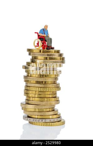 Donna in sedia a rotelle su mucchio di soldi, foto simbolica per l'indennità di assistenza, costi sanitari Austria Foto Stock