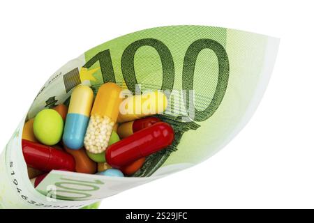 Tavolette e banconote da cento euro foto simbolica: Costi per la medicina e i farmaci dell'industria farmaceutica Austria Foto Stock