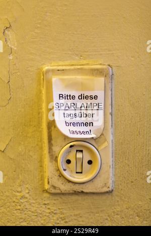 Vecchio interruttore luminoso con etichetta, lasciare accesa la lampadina a risparmio energetico durante il giorno in Austria Foto Stock