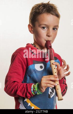 Un bambino suona un flauto sul legno. Educazione musicale e scuola di musica. Austria Foto Stock