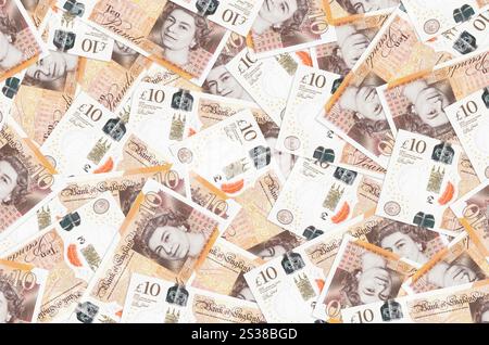Le banconote da 10 sterline britanniche sono in grande pila. Un ricco background concettuale. Grande somma di denaro. Le banconote da 10 sterline britanniche sono in grande pila. Vita ricca Foto Stock