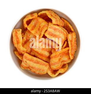 Patatine di pancetta. Deliziosi spuntini con pancetta isolati su sfondo bianco. Pancetta con spuntini salati in pellet. Patatine affumicate al gusto di bacon. Foto Stock