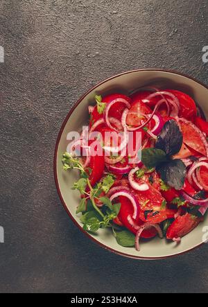 Insalata di pomodori freschi, con cipolla rossa, spezie ed erbe aromatiche, vista dall'alto, primo piano, fatti in casa Foto Stock