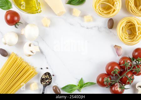 Cornice di ingredienti per cucinare la pasta su sfondo bianco, vista dall'alto. Tagliatelle, pomodori, parmigiano. Foto Stock