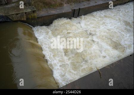 Un fiume potente che scorre sopra una diga. La forza dell'acqua è davvero mozzafiato. Foto Stock