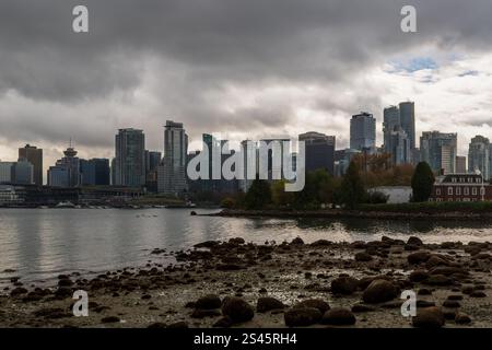 Il centro di Vancouver e l'isola Deadman visti da Stanley Park attraverso Coal Harbour in una giornata nuvolosa, British Columbia, Canada. Foto Stock