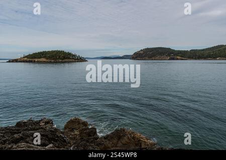 Deception Island è visibile in una giornata nuvolosa dalla spiaggia del bellissimo Deception Pass State Park, Washington State, USA. Foto Stock
