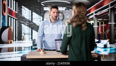 L'uomo dell'hotel parla con la receptionist. Travel Vacation Lifestyle Foto Stock