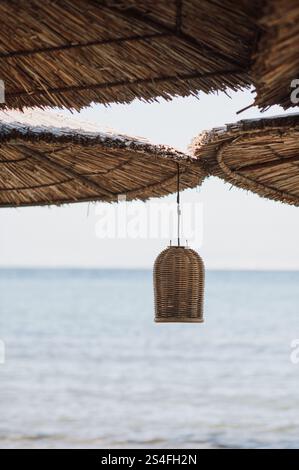 ombra sulla spiaggia con ombrelloni di paglia tazze e decorazioni rustiche Foto Stock