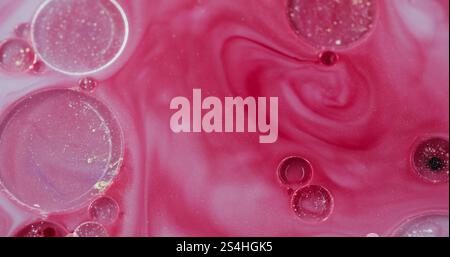 Flusso di bolle di vernice. Agitazione liquida in marmo. Goccia di olio oscillante. Collisione con glitter rosa. Componente di emulsione opaco. Effetto curvo a spirale con strisce ondulate. Foto Stock