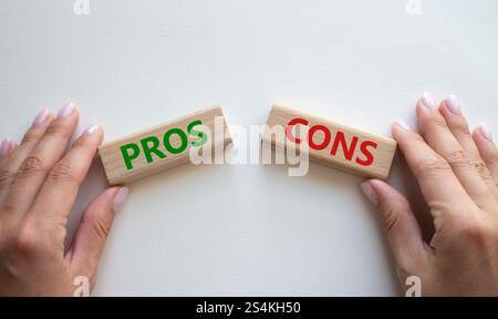 Simbolo pro e contro. Parola concettuale Pro vs contro su blocchi di legno. Mano d'affari. Splendido sfondo bianco. Business e Pro vs Cons Concept. Copia Foto Stock