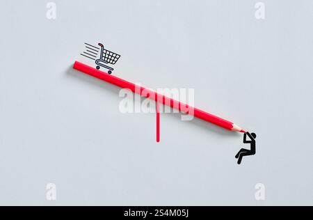 Carrello della spesa e uomo d'affari in equilibrio su una matita, simboleggiando la natura frenetica del consumismo e del commercio. Sconti, sconti e acquisti Foto Stock