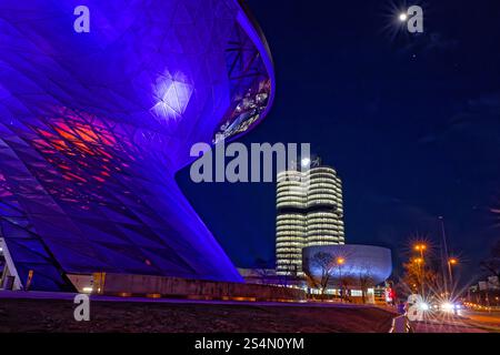 Moderne Architektur bei Nacht. Die BMW-Welt und der BMW-Turm am Abend. Ausstellungsstätte und Hauptverwaltung des Fahrzeugherstellers BMW a München. München Bayern Deutschland *** architettura moderna di notte BMW Welt e la torre BMW di notte Centro esposizioni e sede del costruttore di veicoli BMW a Monaco di Baviera Baviera Germania Copyright: XRolfxPossx Foto Stock