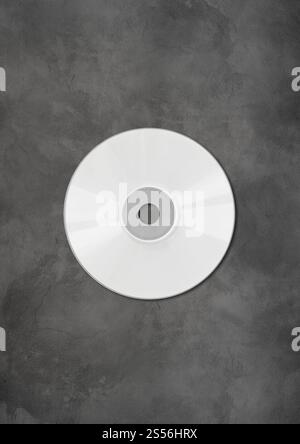 Modello di mockup di etichette CD - DVD bianco isolato su sfondo in cemento. Modello CD - DVD mockup bianco isolato su sfondo in cemento Foto Stock