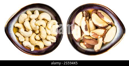 set di noci e anacardi brasiliani in ciotole di ceramica isolate su sfondo bianco Foto Stock