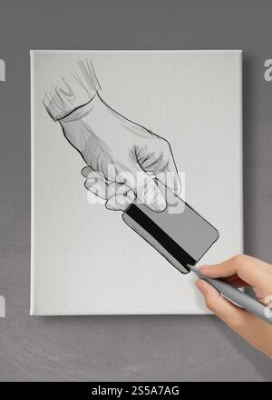 Disegno a mano mano che tiene su carta di credito su cartone telato come concetto Foto Stock