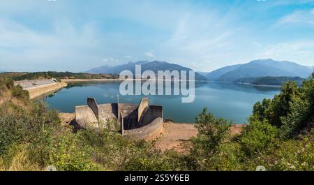 Debar paesaggio estivo del lago con costruzione di drenaggio dell'acqua vicino alla centrale idroelettrica di Shpilje, e sullo sfondo delle montagne. Macedonia del Nord no Foto Stock