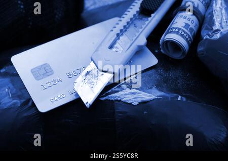 Il cucchiaio pieno di eroina e il coltello di carta giace sui pacchetti di droga e sulla carta di credito con rotolo di dollari. Concetto di traffico e traffico di droga negli Stati Uniti Foto Stock